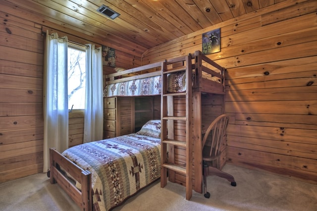 bedroom featuring wood ceiling, carpet, and wood walls