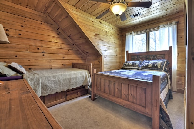 carpeted bedroom with visible vents, ceiling fan, wood walls, lofted ceiling, and wooden ceiling