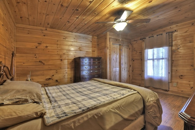 bedroom featuring wooden walls, wooden ceiling, ceiling fan, and wood finished floors