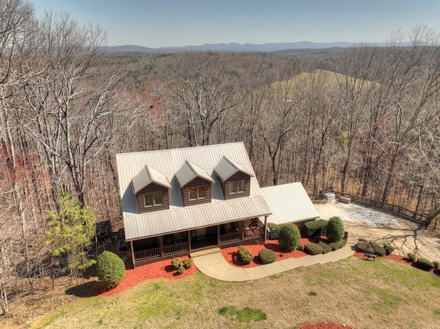 drone / aerial view with a mountain view and a wooded view