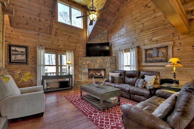 living room with wood-type flooring, wood walls, a fireplace, wood ceiling, and ceiling fan