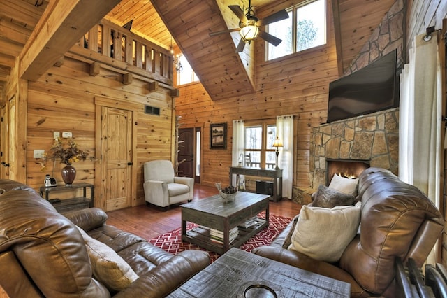 living area with wood finished floors, a ceiling fan, wood walls, and wooden ceiling