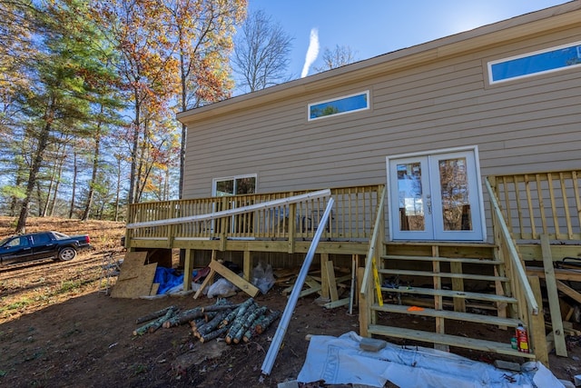 rear view of property featuring a wooden deck and french doors