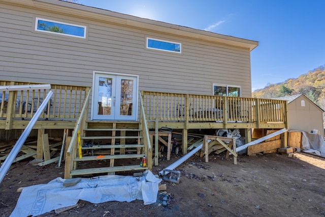 rear view of property featuring a deck with mountain view