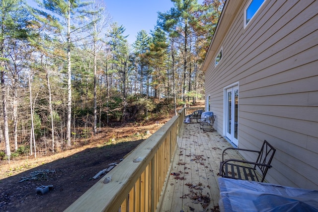 wooden balcony featuring a wooden deck and french doors