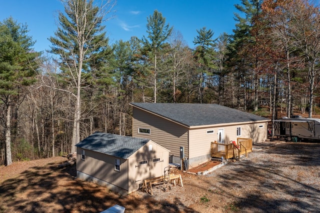 view of home's exterior with an outbuilding