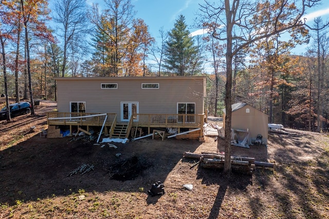 rear view of house featuring a shed and a deck