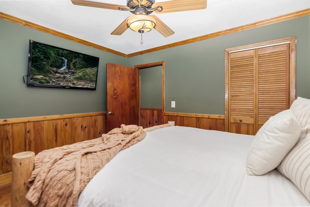 165 Timberwalk Dr, Ellijay, GA 30540 - bedroom with a wainscoted wall, ornamental molding, a closet, wooden walls, and ceiling fan
