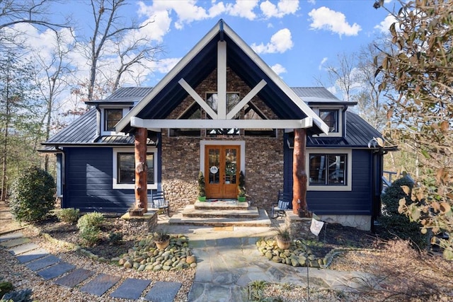 view of front facade featuring french doors, metal roof, and a standing seam roof