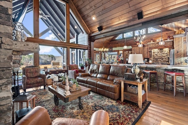 living room with a chandelier, high vaulted ceiling, wood finished floors, wood ceiling, and beam ceiling