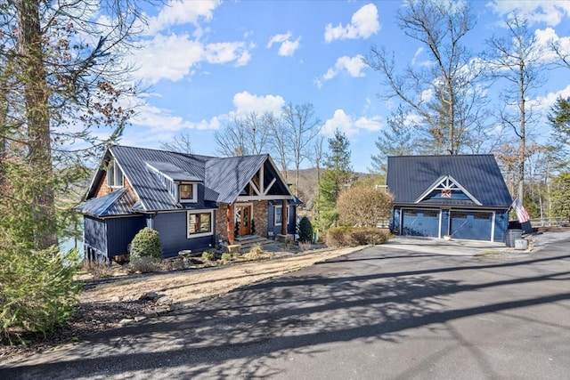 view of front of home with a garage and metal roof