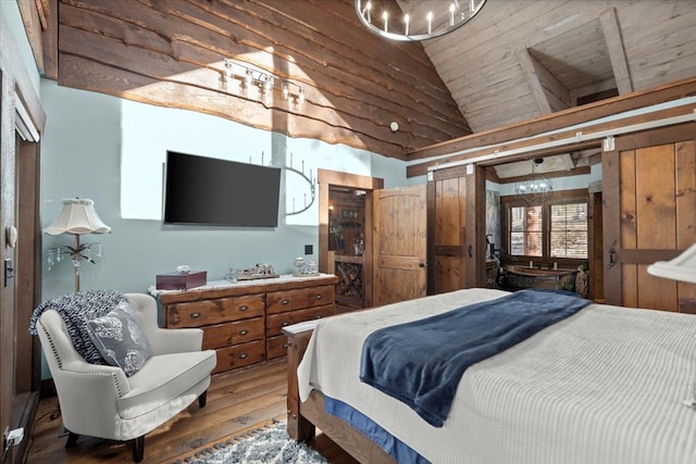 bedroom featuring lofted ceiling and wood finished floors