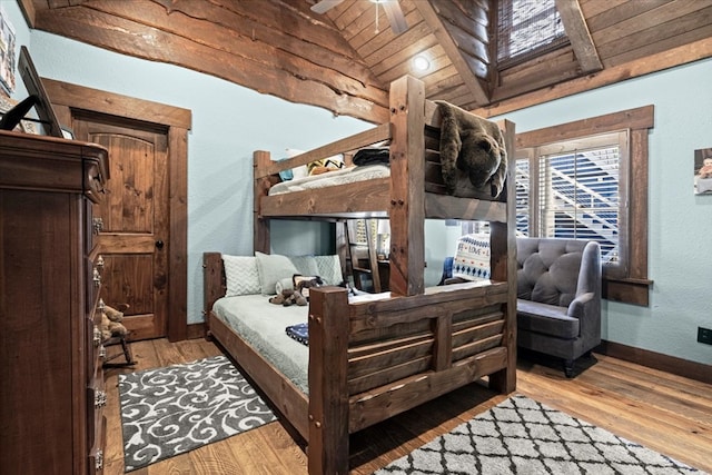 bedroom with baseboards, a textured wall, lofted ceiling, wooden ceiling, and light wood-style floors