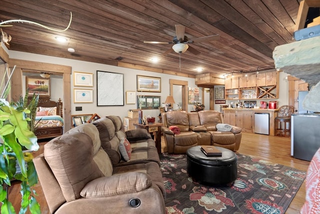 living room with wet bar, wooden ceiling, ceiling fan, and light wood-style flooring