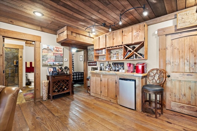 kitchen featuring open shelves, light countertops, light wood-style floors, wooden ceiling, and stainless steel fridge