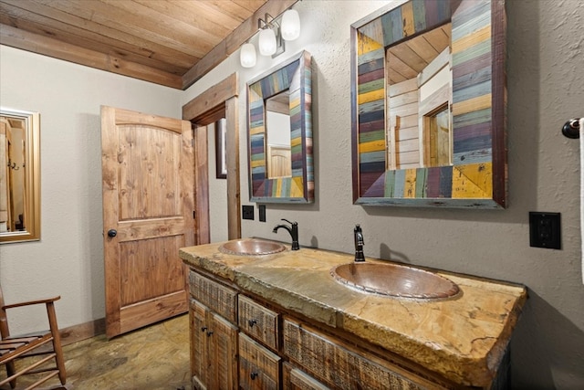 bathroom with double vanity, wooden ceiling, a sink, and stone finish flooring