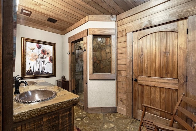 bathroom featuring wooden ceiling and vanity