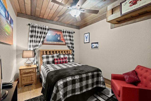 bedroom featuring a textured wall, wooden ceiling, and wood finished floors