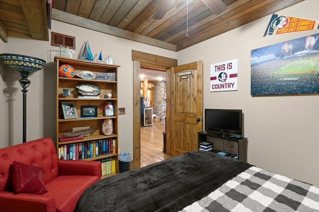 bedroom featuring light wood-type flooring, wooden ceiling, and visible vents