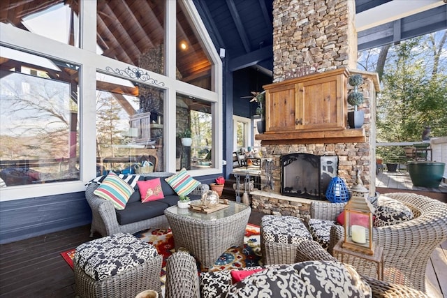 exterior space featuring high vaulted ceiling, an outdoor stone fireplace, wood finished floors, wood ceiling, and beamed ceiling