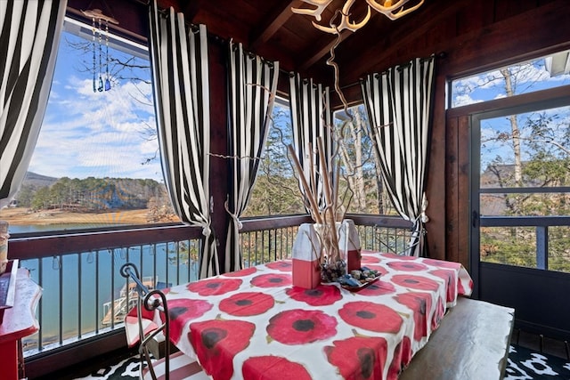 sunroom / solarium featuring wood ceiling, a water view, a wealth of natural light, and vaulted ceiling with beams