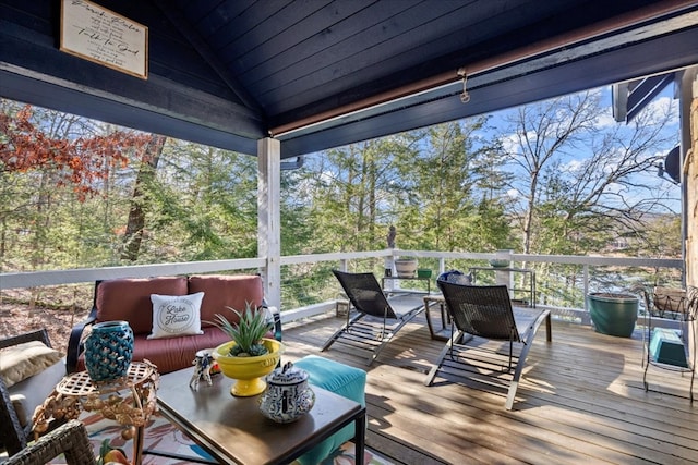 sunroom / solarium featuring vaulted ceiling