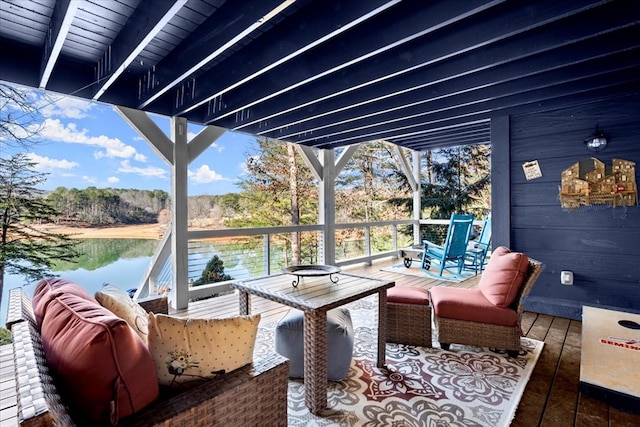 wooden deck with a water view and outdoor lounge area