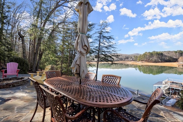 view of patio / terrace featuring a water view and a fire pit