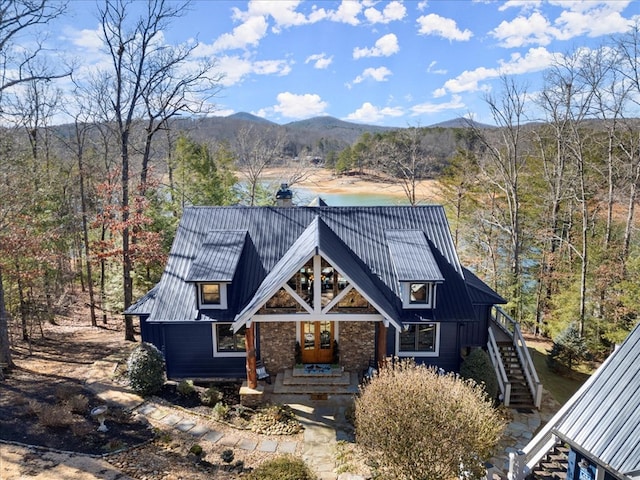 view of front of house featuring stairs, metal roof, a standing seam roof, and a mountain view