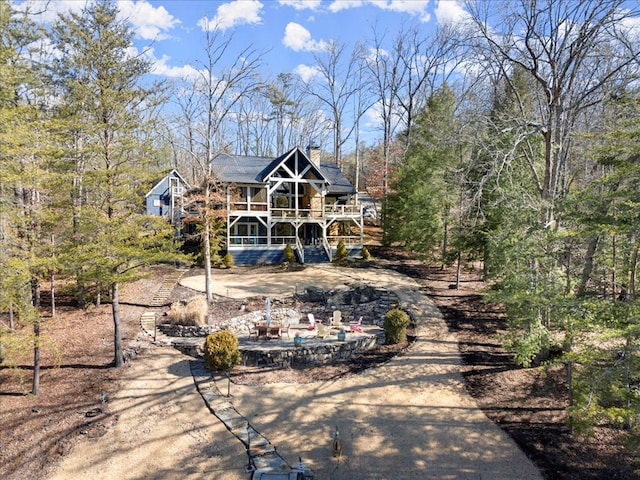 rear view of property featuring a chimney