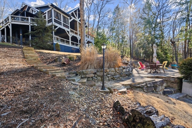 view of yard featuring a sunroom and a patio