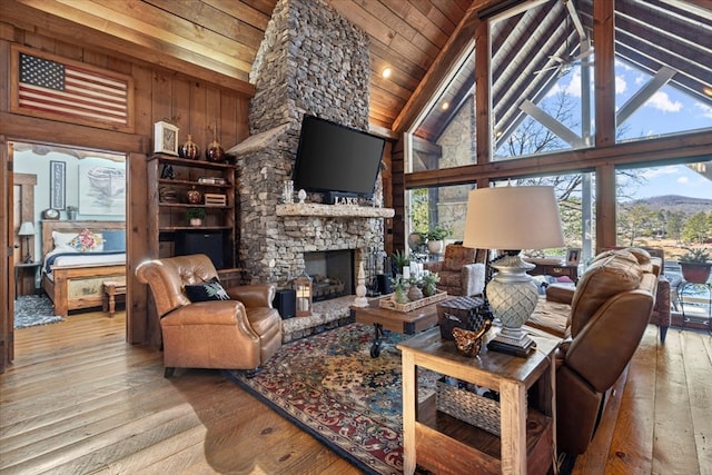 living room featuring light wood-type flooring, wood ceiling, and plenty of natural light