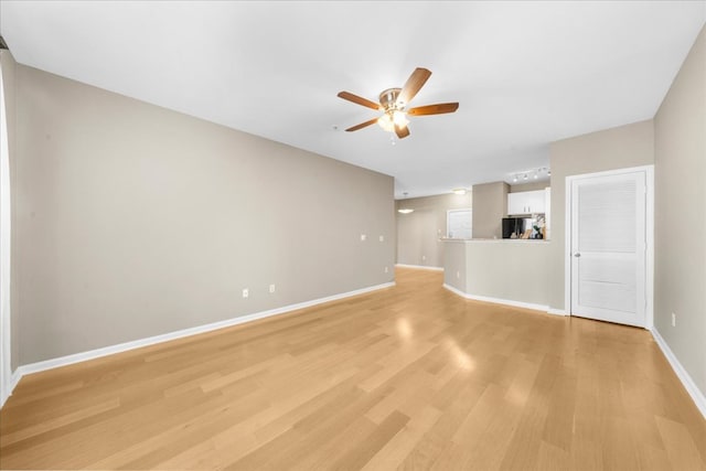 unfurnished living room with ceiling fan and light wood-type flooring