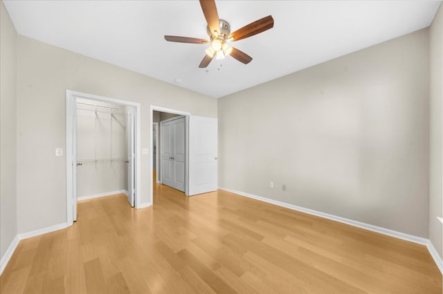 unfurnished bedroom featuring ceiling fan, light wood-type flooring, and a closet