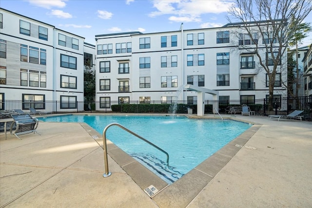 view of swimming pool with a patio and pool water feature