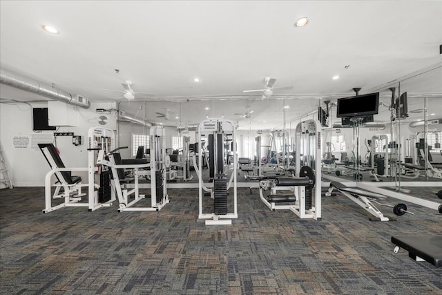 workout area featuring dark colored carpet and ceiling fan