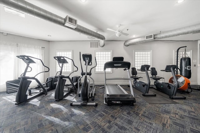 exercise room featuring ceiling fan and dark colored carpet