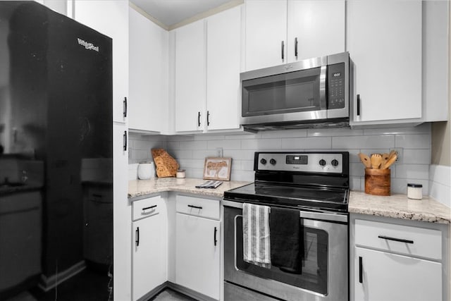 kitchen featuring stainless steel appliances and white cabinets