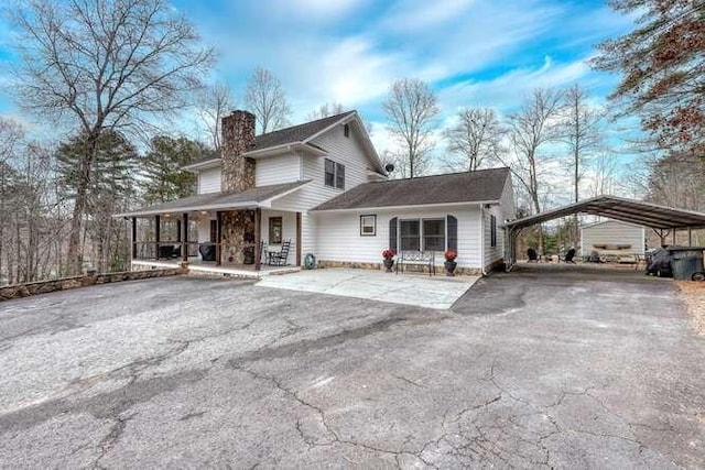 view of front facade with a porch and a carport