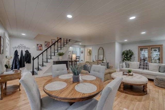 dining room with wooden ceiling and light wood-type flooring