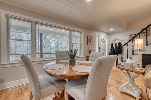 dining room featuring wooden ceiling and light wood-type flooring