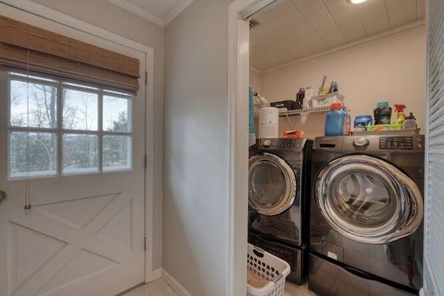 washroom featuring separate washer and dryer and crown molding