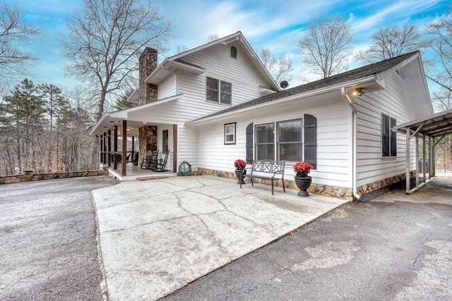 back of property featuring a porch