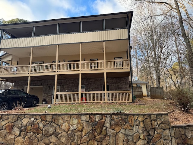 rear view of property with a balcony and a garage