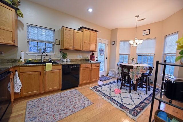 kitchen with sink, range, hanging light fixtures, black dishwasher, and light hardwood / wood-style floors