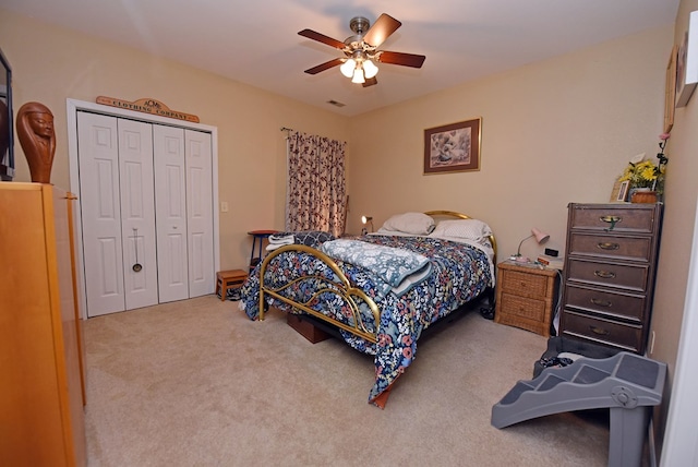 bedroom featuring ceiling fan, carpet, and a closet