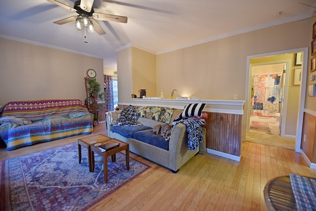 living room with crown molding, light hardwood / wood-style flooring, and ceiling fan