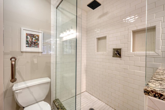 bathroom with walk in shower, vanity, and toilet