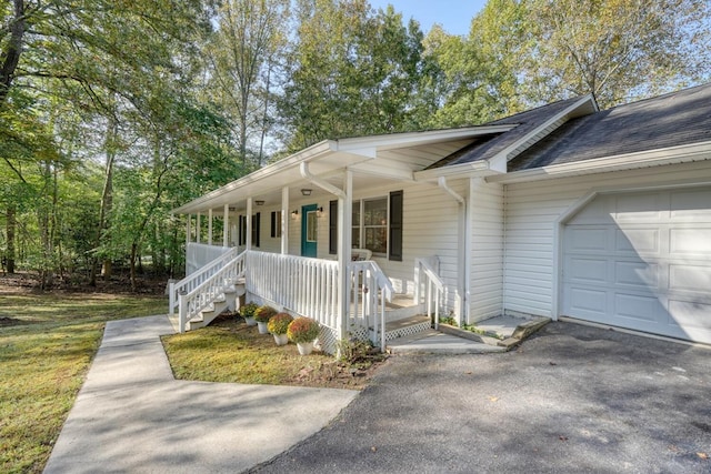 exterior space with a porch and a garage