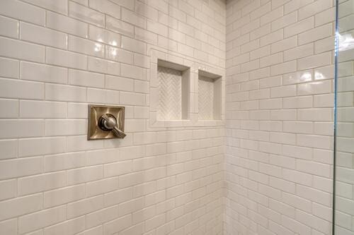 interior details featuring tiled shower